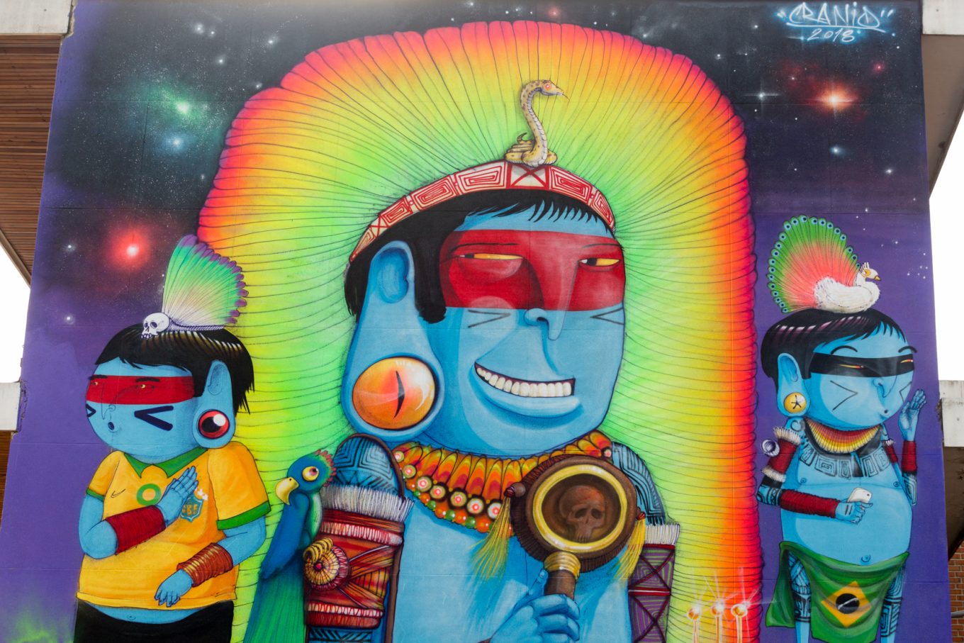 Mural dioses centroamericanos en fachada de edificio