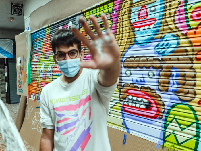 El artista Juay junto a su mural del Mercado de los Mostenses