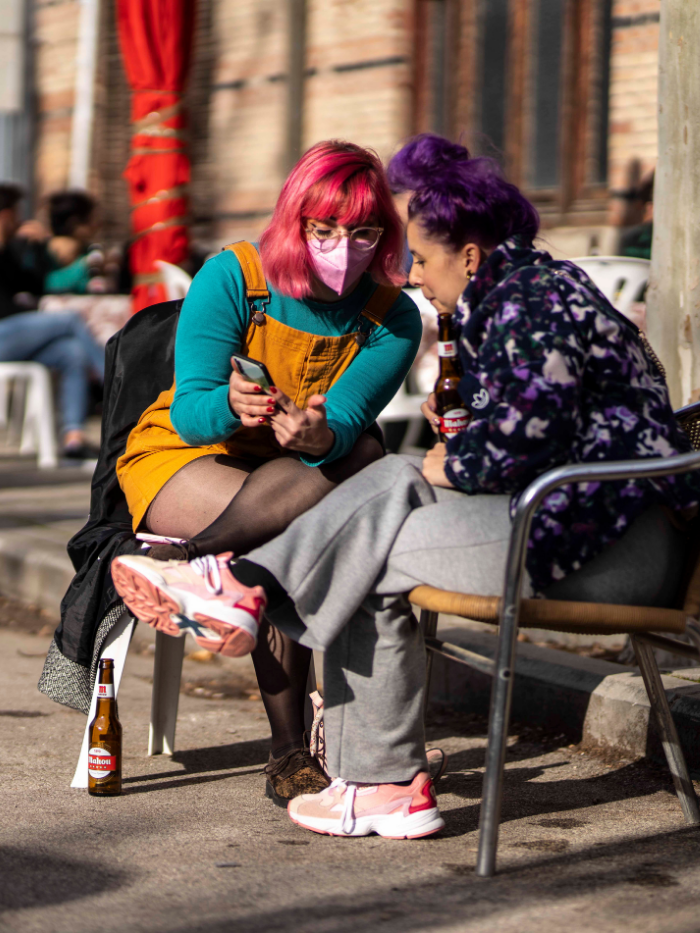 Dos amigas miran un teléfono móvil