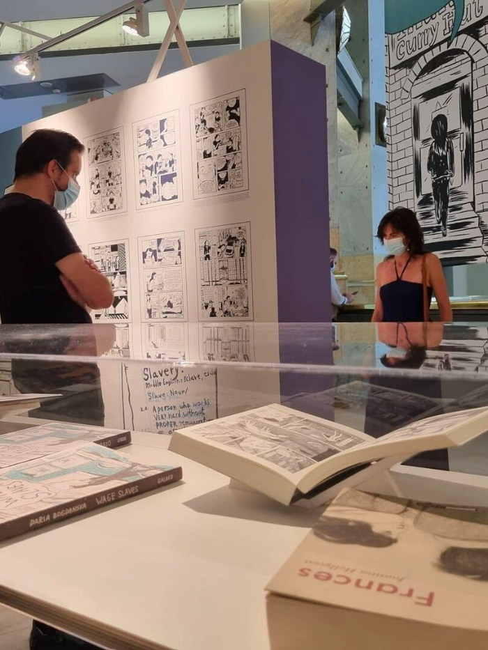 Dos visitantes observan los paneles de la exposición 'Aquí Llegan Ellas' en Centro Centro Cibeles