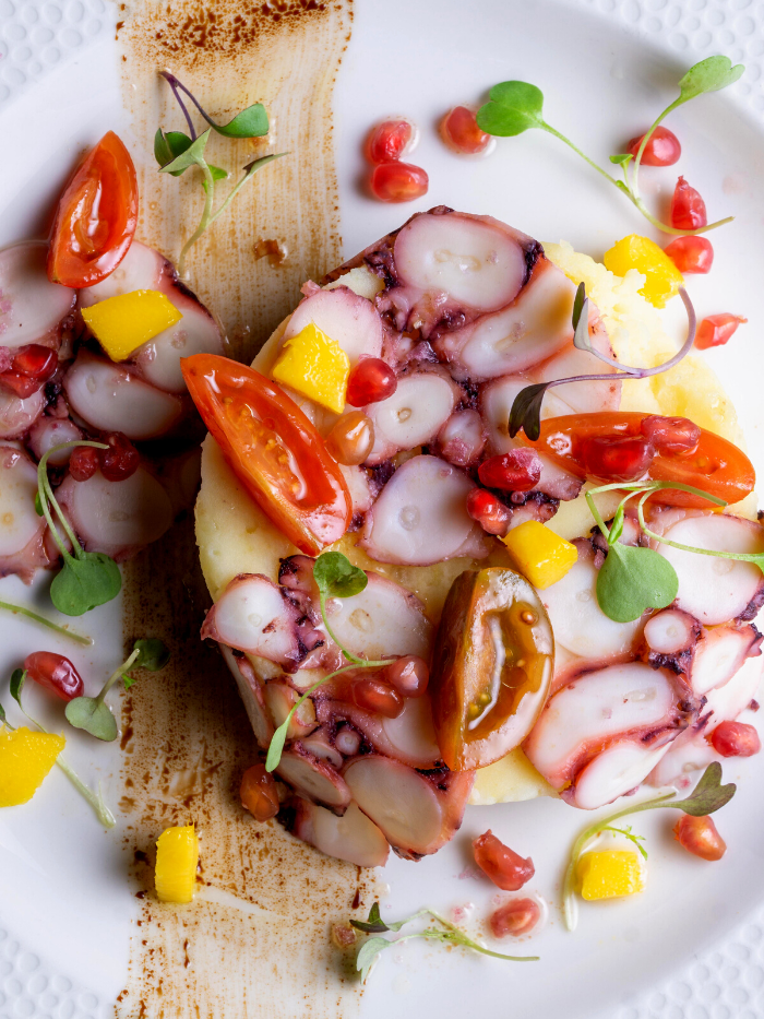 Plato de pulpo con tomates cherry y granada