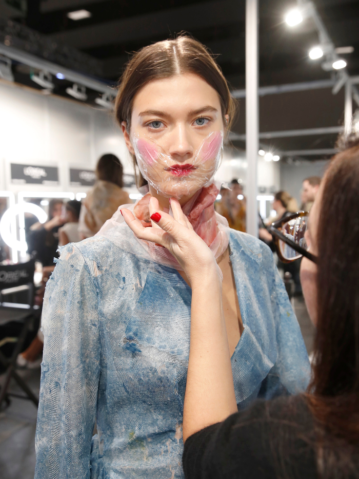 Modelo con maquilladora en Mercedes Benz Fashion Week 2024